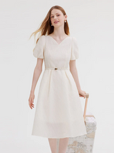 a lady in white v-neck jacquard dress